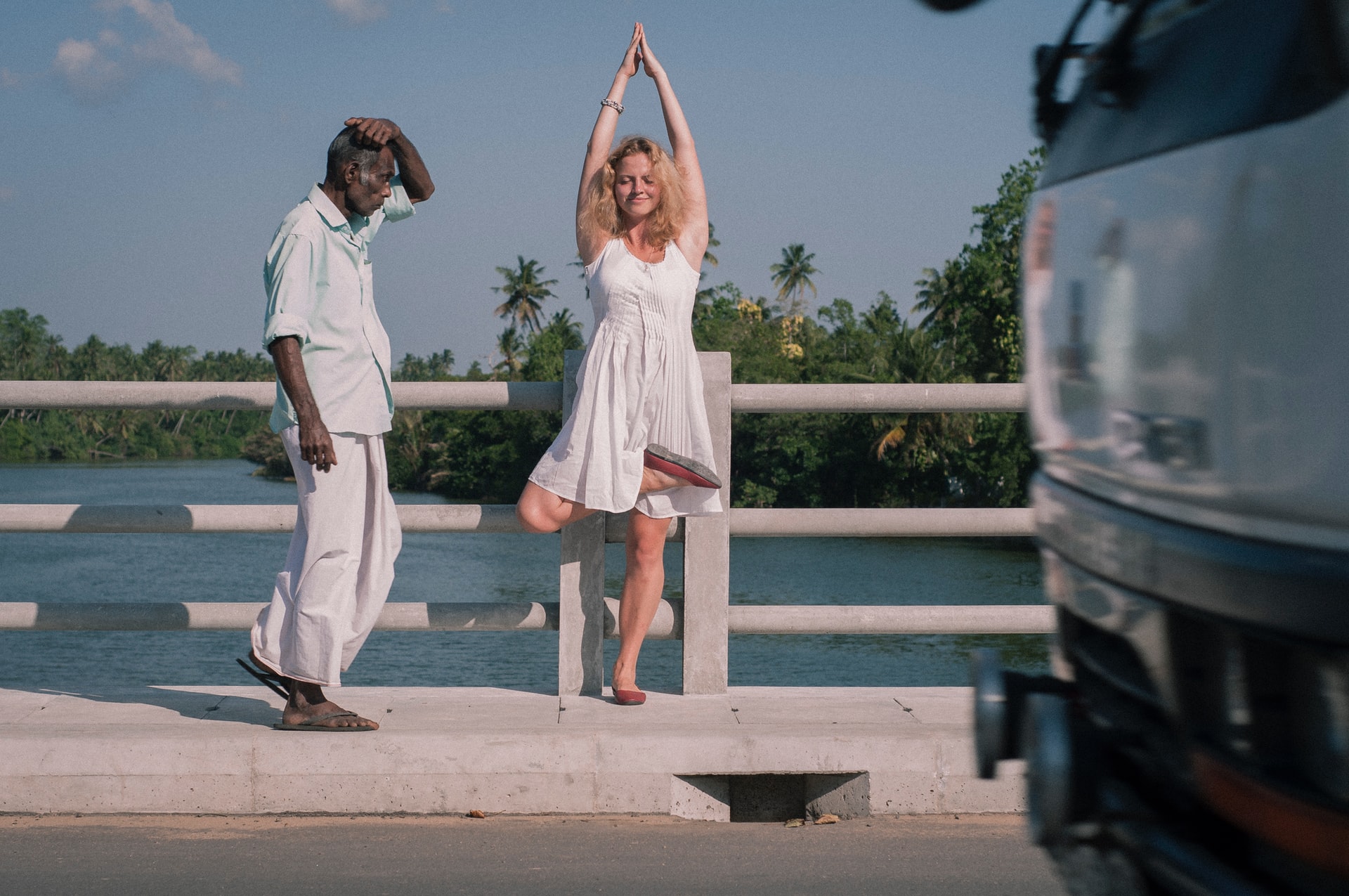 Woman doing yoga pose on the side walk